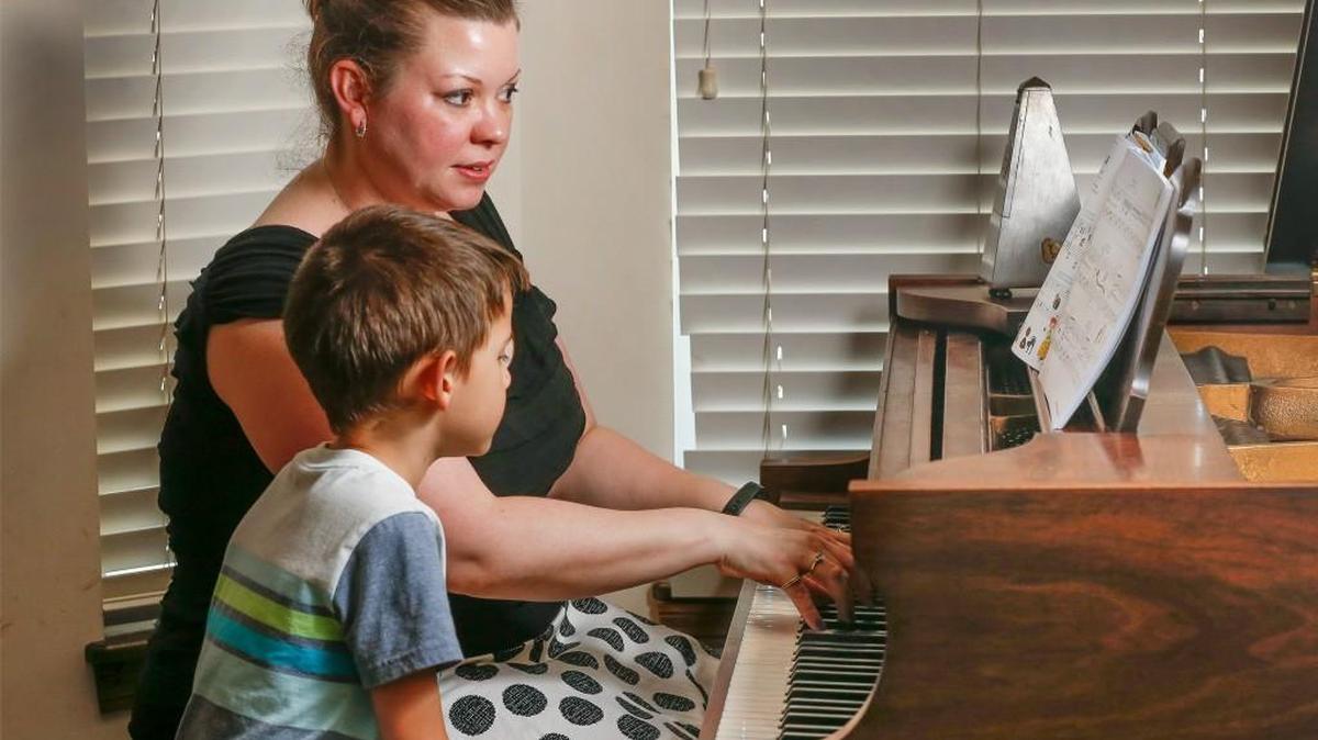 Julia Powell gives a piano lesson to her student Henry at a home in Valley Center.