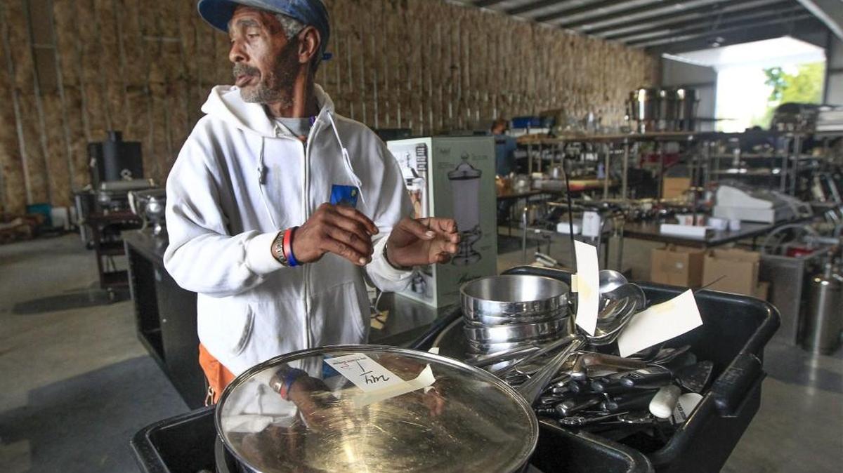 Donald Lawson gathers kitchen equipment at an auction for Premier Catering. Since summer, the national restaurant industry has faced falling customer traffic and sales. A number of chains have gone into bankruptcy, sold themselves or closed stores.