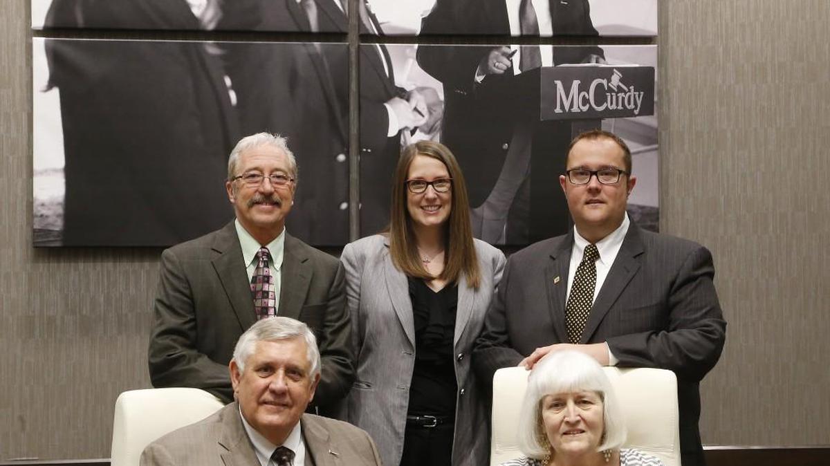 Lonny and Annette McCurdy, front, along with, back row from left, Rick Brock, Megan McCurdy Niedens and her brother, Braden, enjoy helping people through auctions of all sizes.