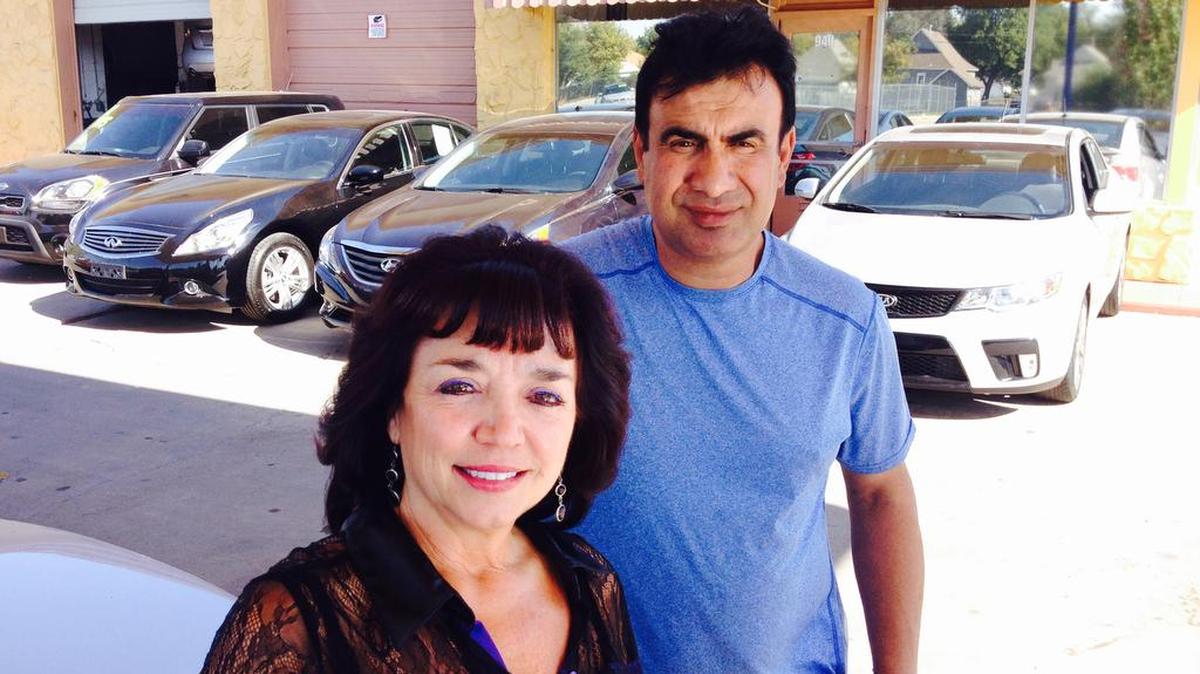Nabil Sayegh, right, opened Automax at the urging of his office manager, Rene Holmes. The South Broadway car lot specializes in vehicles that have been totaled and rebuilt.