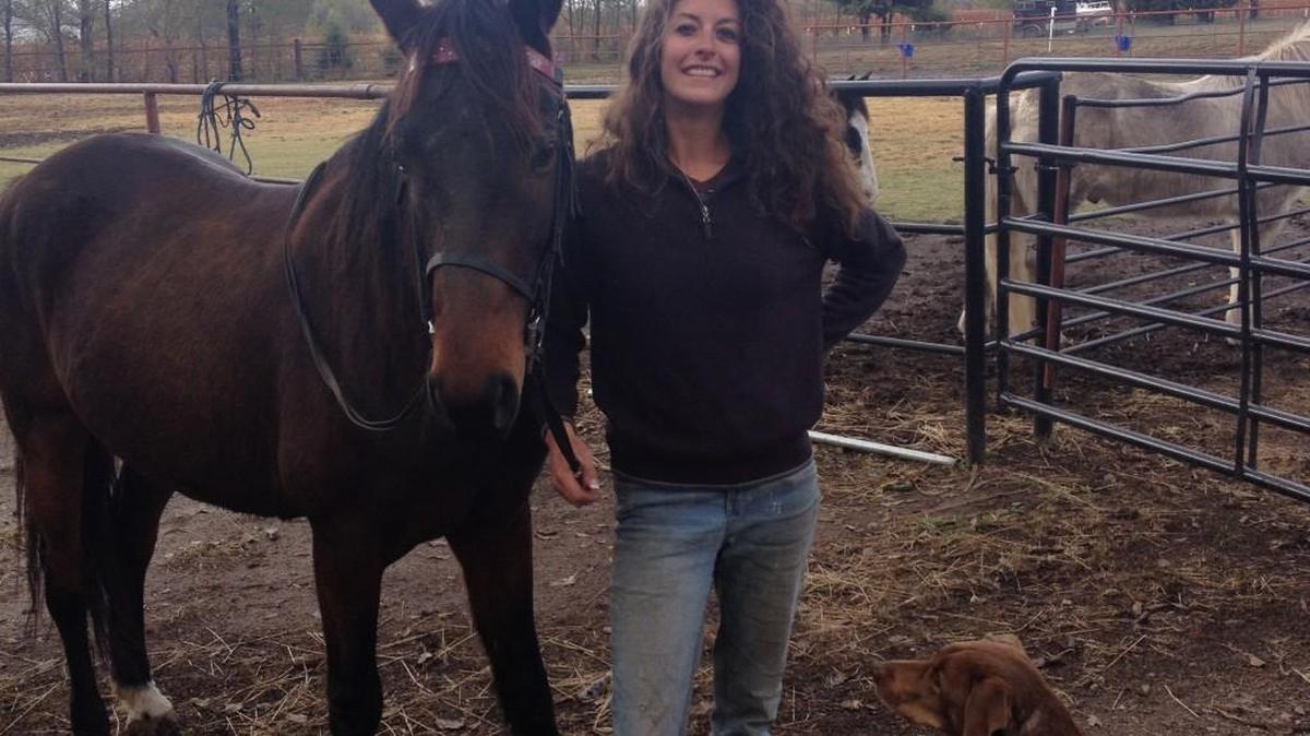 Kelsey Kuhn, owner of Dog Inn Dog Out pet services, is shown with her horse Sebastian and dog Nugget.