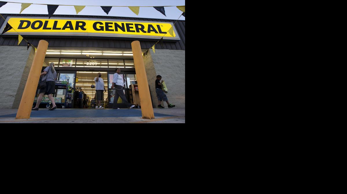 
Customers exit a Dollar General store in San Antonio in September 2013. Dollar General is going hostile with its $9.1 billion bid for Family Dollar after repeated rejections of previous offers by its rival. The discount chain said Wednesday that it is offering investors of Family Dollar Inc. $80 per share in cash, the same offer that was rejected last week by the company board. 
