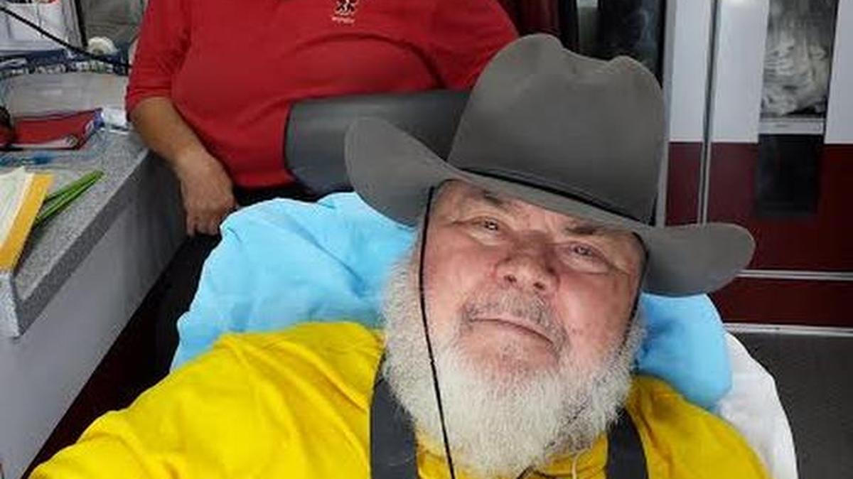 
Tex Bedford, sitting in a medical transport vehicle on Tuesday, sports the reshaped, resized hat that once belonged to his late son, Darrell.
