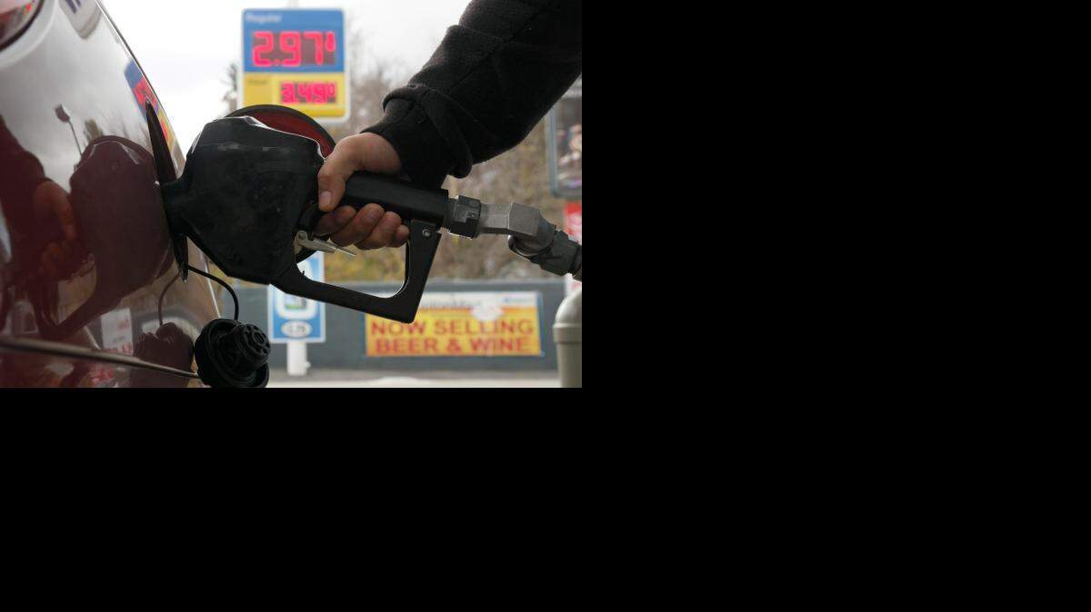 
A driver in Pittsfield, Mass., buys fuel Monday. Gas prices are now under $3 at more than half the stations in the United States, according to GasBuddy.com. While that’s good news for drivers, the outlook is more mixed for states that have sizeable oil industries.
