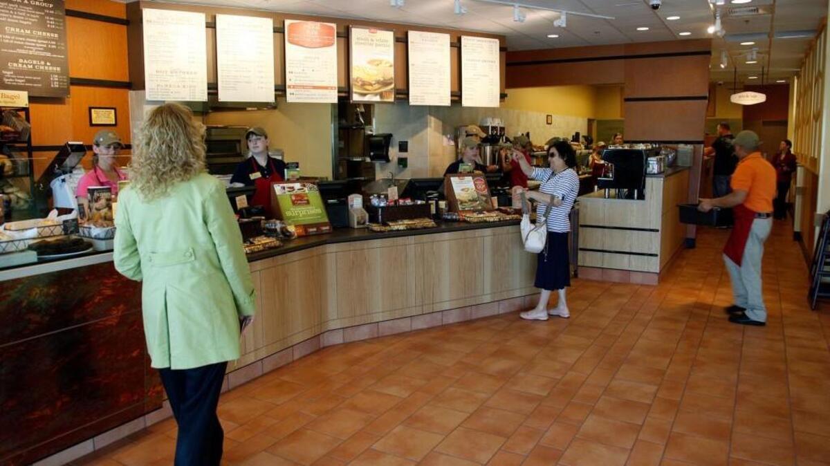 Customers in the Panera Bread Bakery and Cafe on Ridge near Maple.