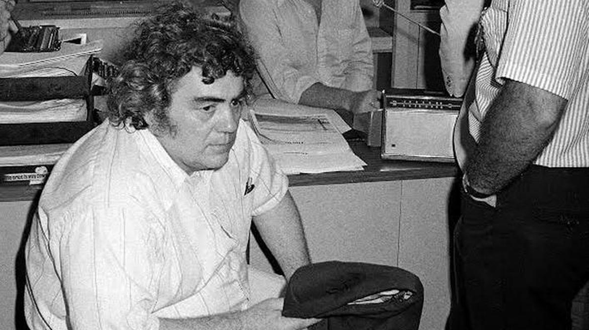 In this Aug. 11, 1977, file photo, New York Daily News columnist Jimmy Breslin, left, sits at police headquarters in New York after the arrest of David Berkowitz, the Son of Sam serial killer suspect who had contacted Breslin with several cryptic messages during the killing spree. Breslin, the 88-year-old Pulitzer Prize-winning chronicler of wise guys and underdogs who became the brash embodiment of the old-time, street-smart New Yorker, died Sunday.
