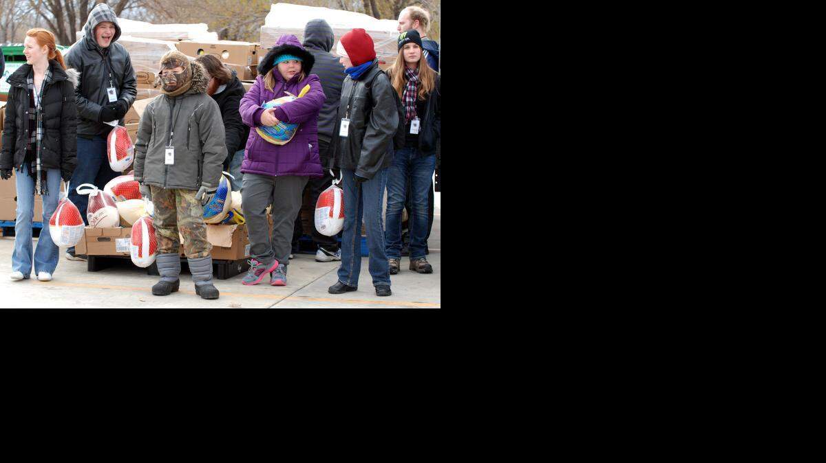 
Volunteers wait at the Bread of Life food warehouse in south Wichita for the annual Thanksgiving food giveaway.
