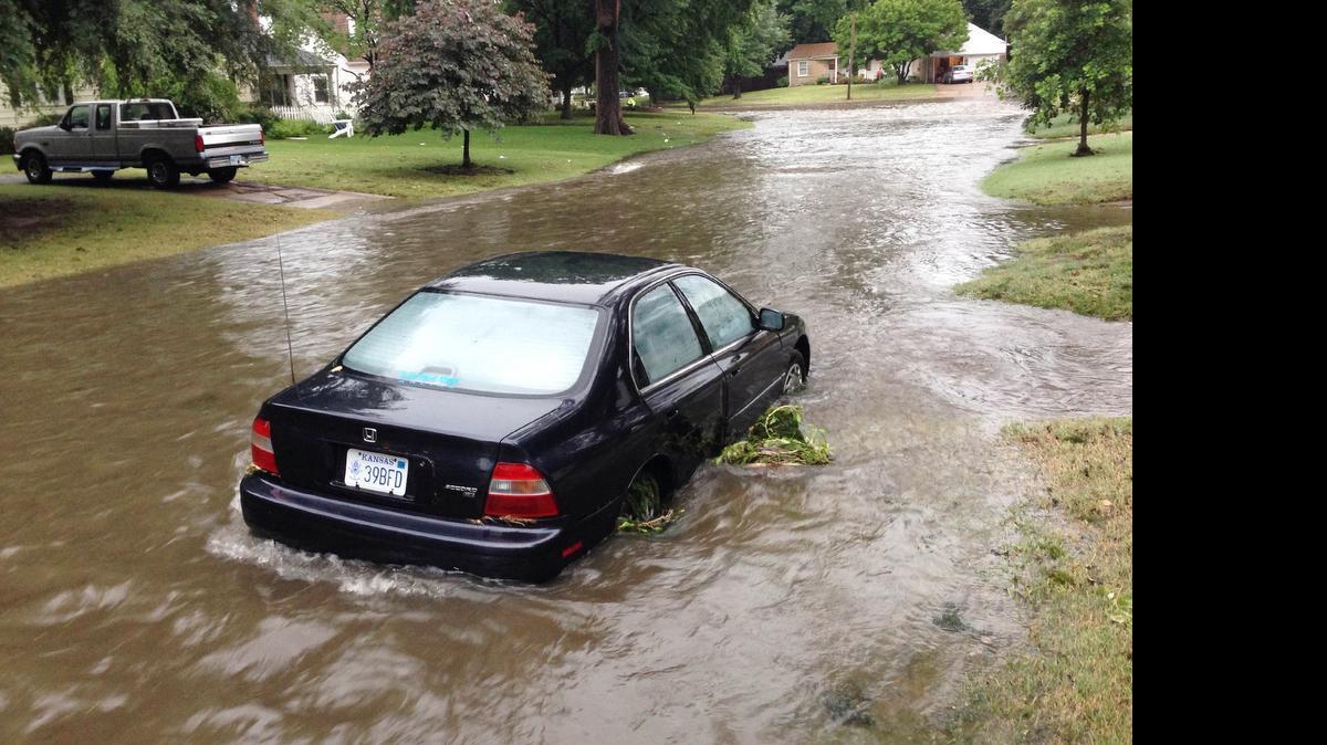 A car sits on a flooded Bleckley street in east Wichita on Monday evening after heavy rains hit the area. Area experts say that can really damage a vehicle’s engine.

