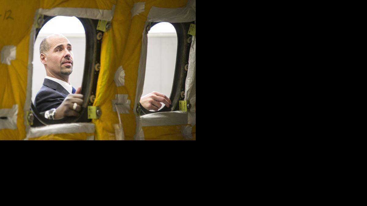 
Exploration Place Board of Trustees member Jason Beckmann looks over the fuselage of a Hawker 4000 that will be on exhibit in the museum’s renovated aviation exhibit called “Design, Build, Fly.” (Feb. 18, 2015)

