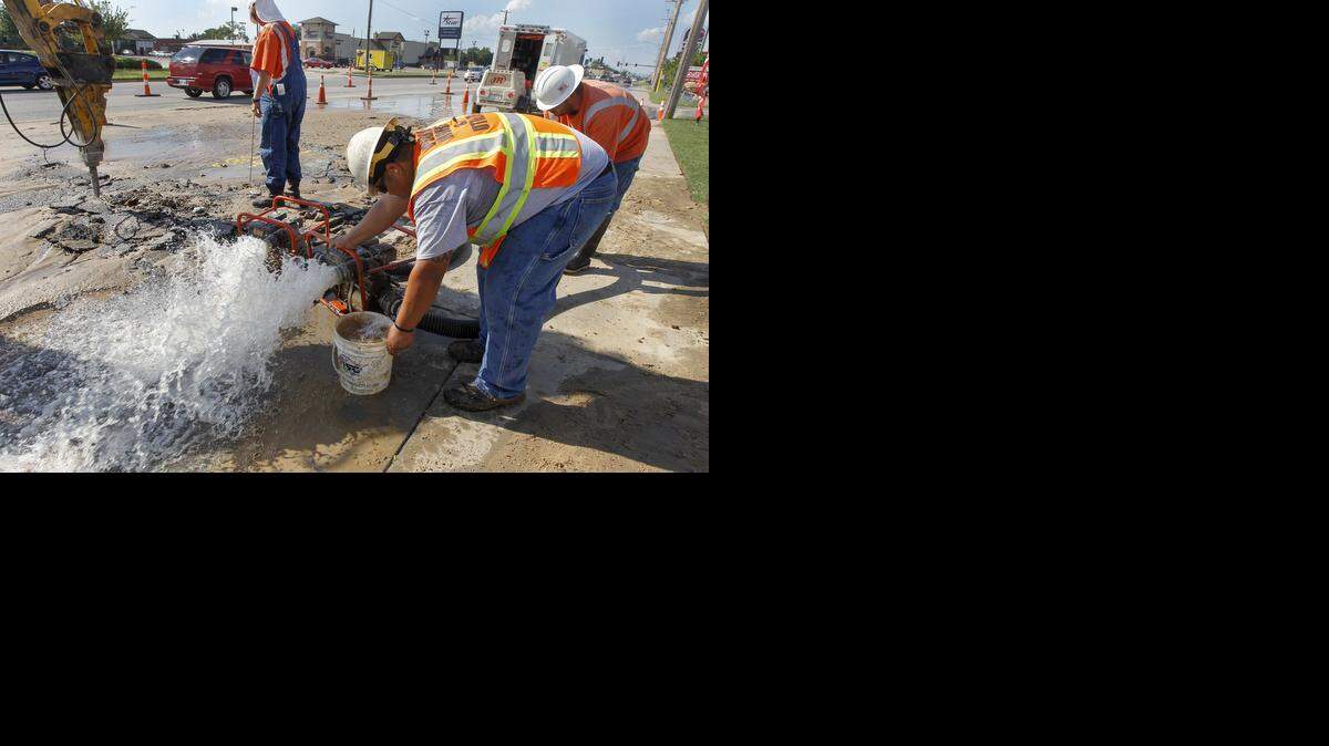 
City workers fix a water main break near West and Maple on Saturday, Aug. 16, 2014.
