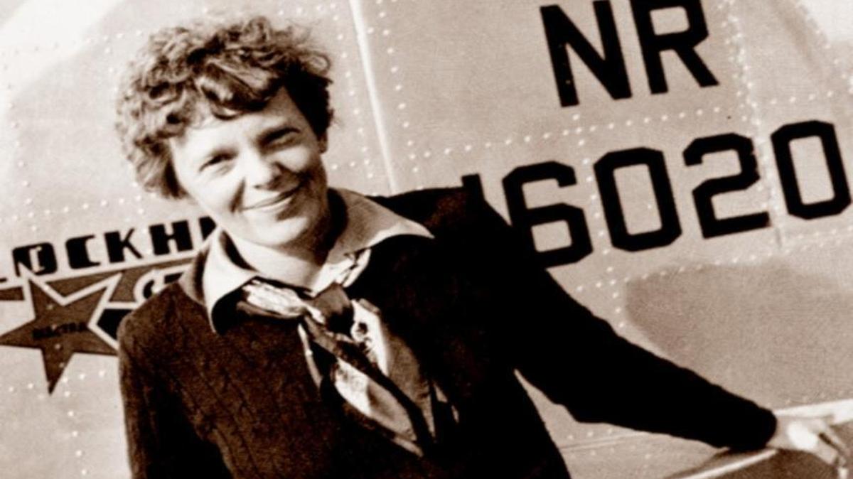 This May 20, 1937 photo, provided by The Paragon Agency, shows aviator Amelia Earhart at the tail of her Electra plane at Burbank Airport in Burbank, Calif. It was a clear spring day in 1937 when Earhart, ready to make history by flying around the world, brought her personal photographer, Albert Bresnik, to a small Southern California airport to document the journey’s beginning.