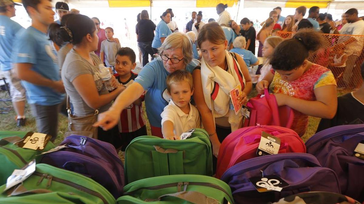 People look over new backpacks during last year’s Convoy of Hope event at Bethel Life Center. This year’s event is expected to draw nearly 10,000 people.