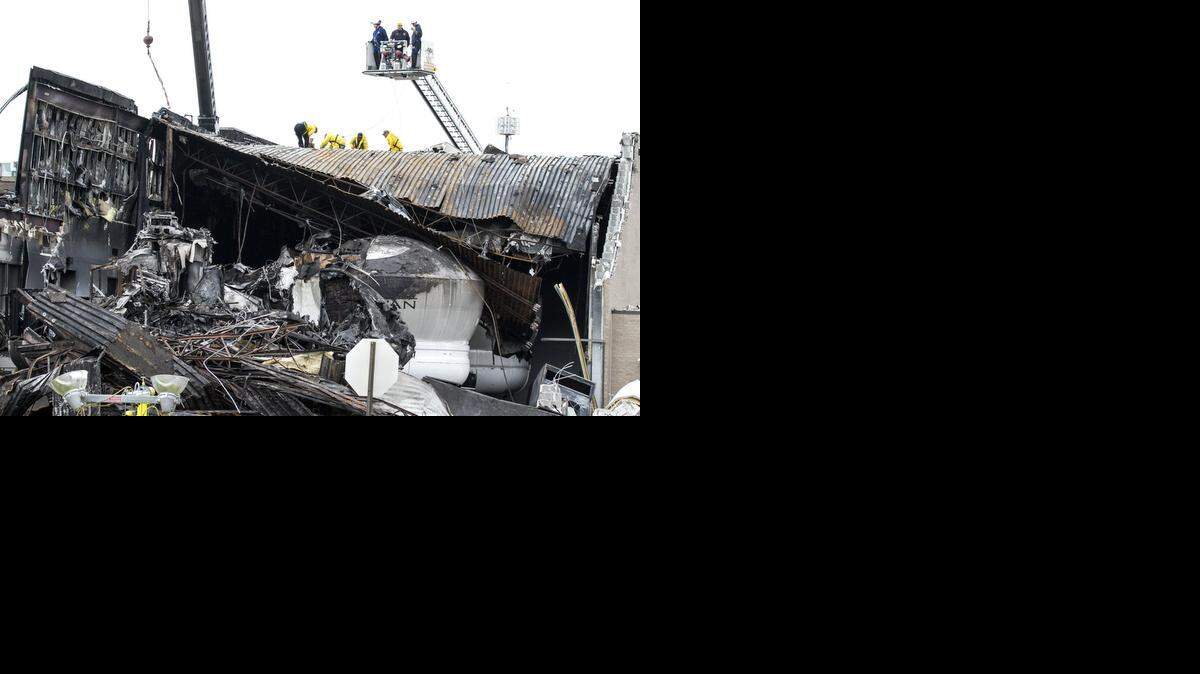 
Contractors hired by the National Transportation and Safety Board work to remove parts of the King Air that crashed into the roof of the FlightSafety building last week. (Nov. 3, 2014) 
