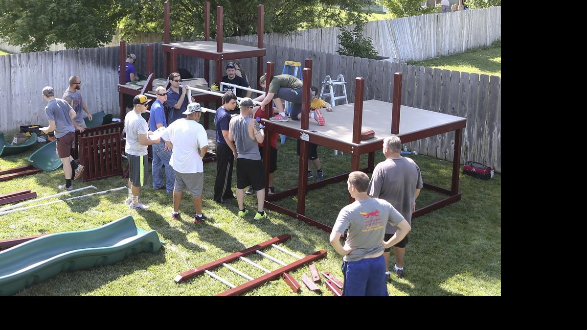 
Volunteers from the Make-a-Wish Foundation set up a play set for Easton Weis, 3, who has a heart defect and chronic lung failure. 
