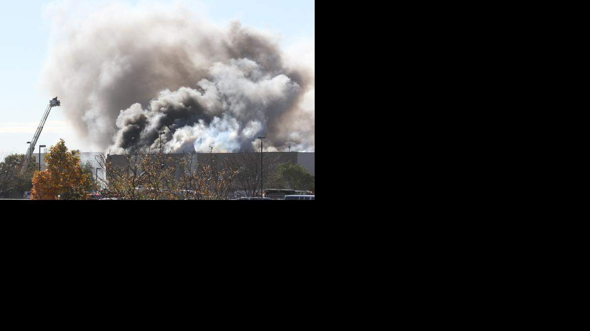 
Firefighters work the scene of a plane crash Oct. 30 at the FlightSafety training center building at Wichita Mid-Continent Airport. A Beechcraft King Air crashed into the building, killing four people including the pilot. 

