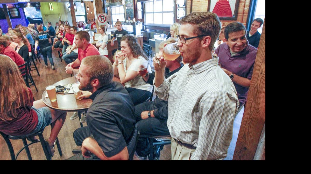 
Young Catholics listen to the Rev. Pat York talk about obedience during a monthly meeting called “Theology on Tap” at the River City Brewery. (June 9, 2015)
