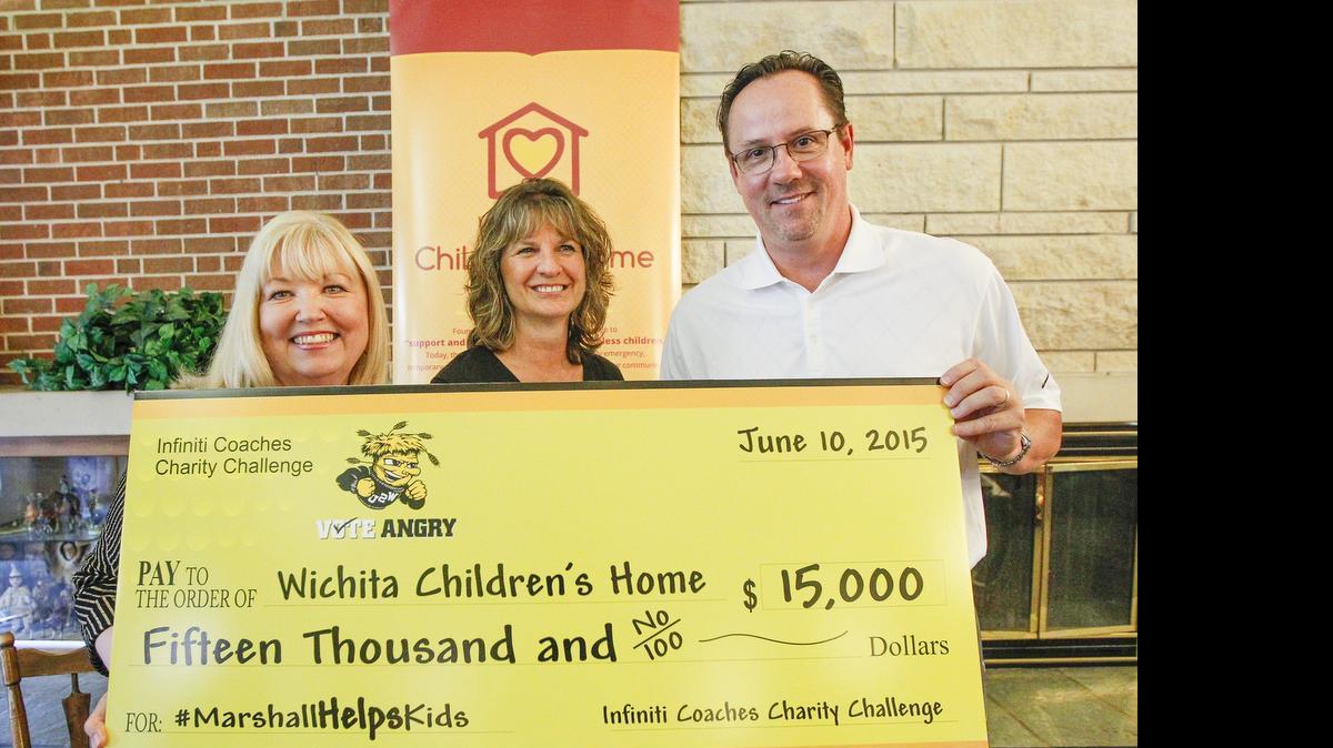 
Wichita State coach Gregg Marshall, right, stands with Children’s Home CEO Debbie Kennedy, left, and Children’s Home board president Barbara Ray and the $15,000 check he won from the Infiniti Coaches Charity Challenge and donated to his favorite charity Wednesday at the Children’s Home. (June 10, 2015)
