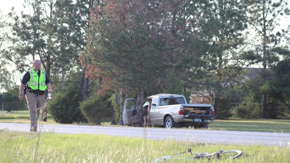 
A pickup sits in a ditch on MacArthur Road after it struck a 63-year-old man riding a bicycle at 135th Street late Friday afternoon. The bicyclist later died.
