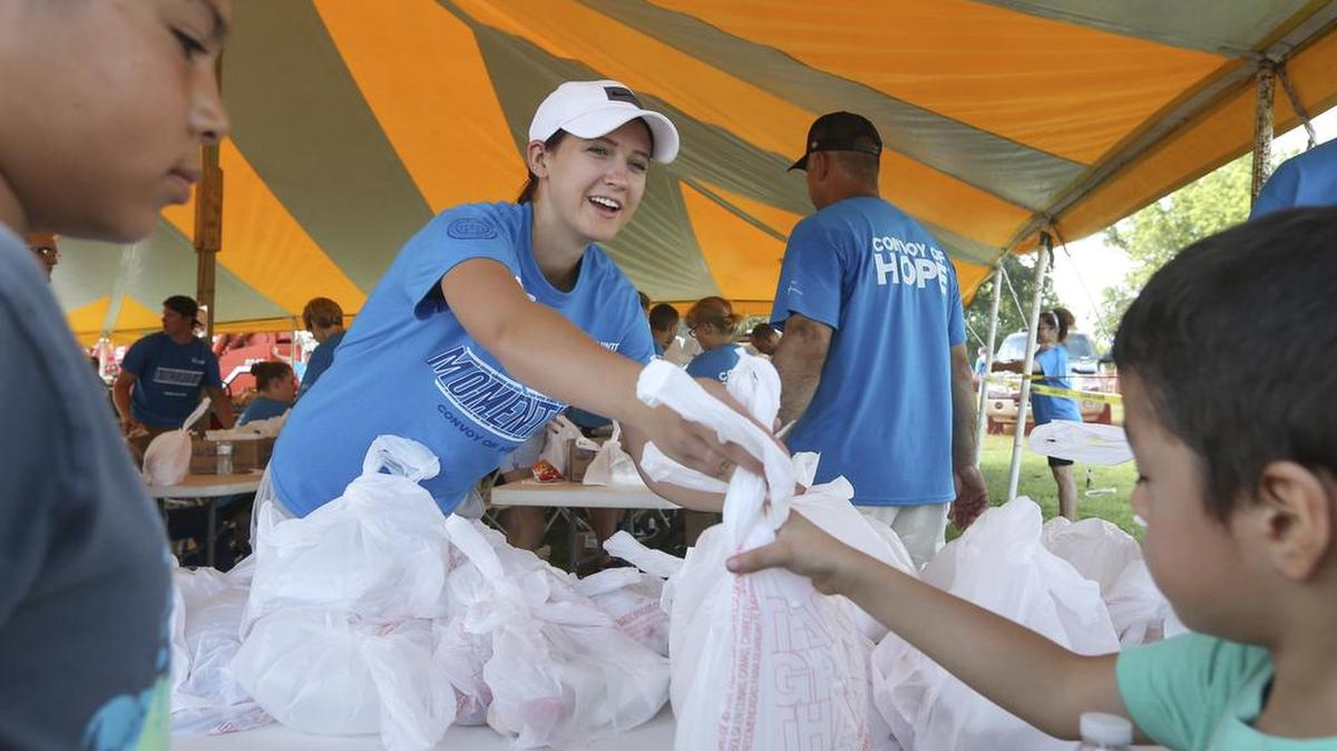 
Volunteer Racheal Page hands out meals during the Convoy of Hope event at the Bethel Life Center on Saturday. Convoy of Hope delivers free food, goods and services to residents in need. 

