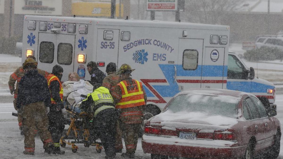 Fire and EMS workers prepare to load a accident victim into a waiting ambulance in 2013.