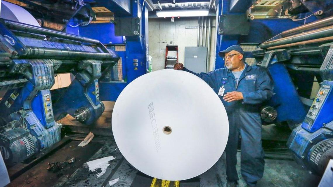 Press operator Stephen Looney gets ready to upload a roll of paper into the press at the Wichita Eagle on Tuesday. (May 24, 2016)