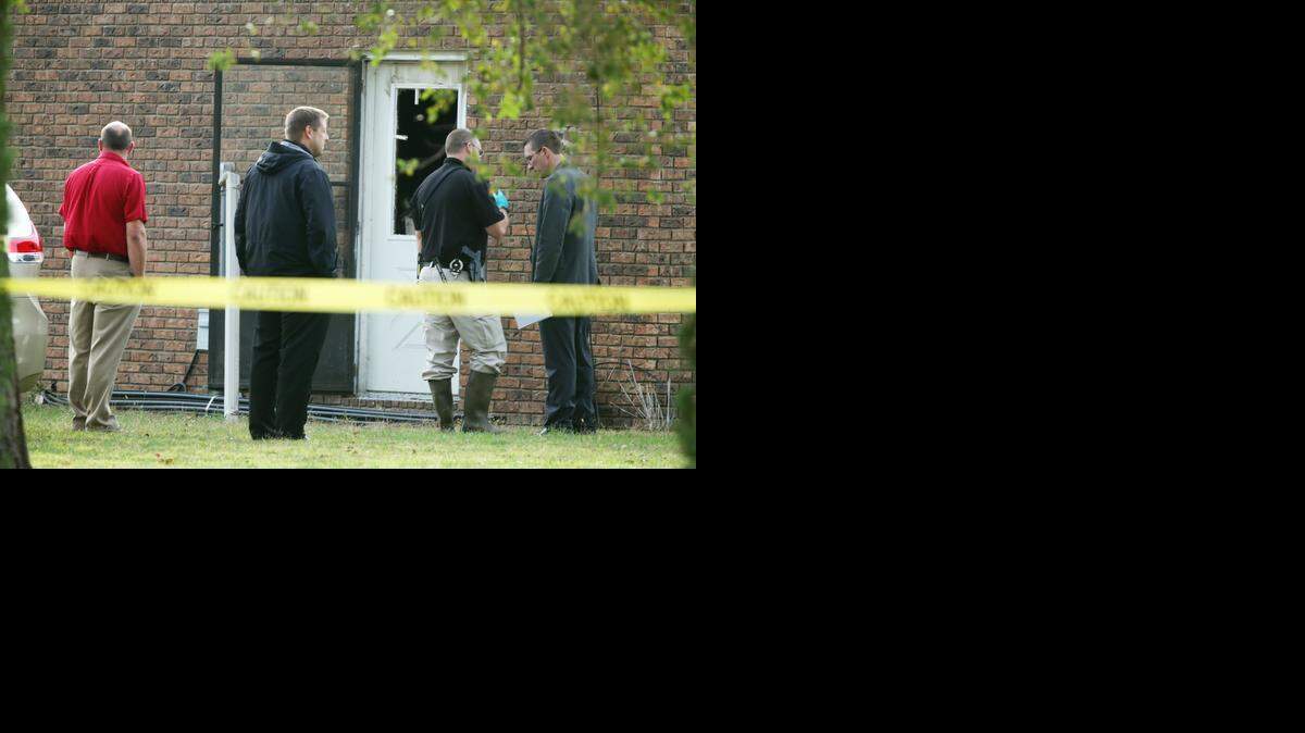 
Firefighters and investigators confer outside a home in the 5100 block on North Ridge Road. A house fire was reported around 8:30 a.m. One person was found dead in the home. (Oct. 24, 2014)
