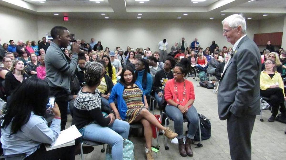 Student body president Joseph Shepard, left, questions WSU President John Bardo, right, at a recent diversity meeting.