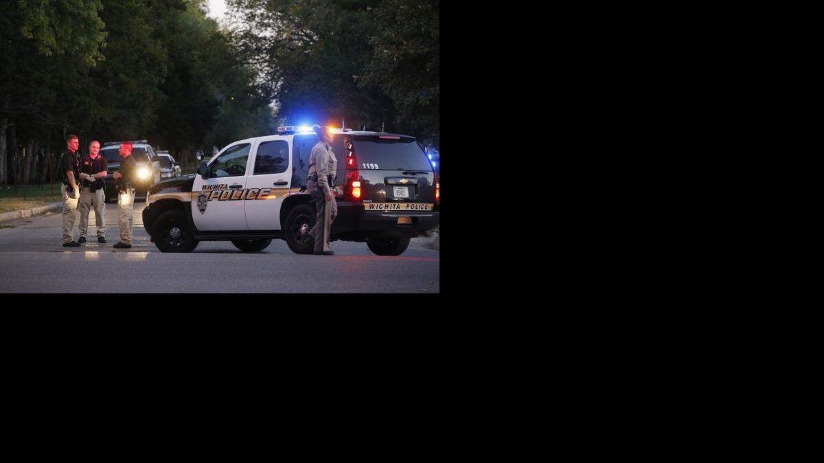 
Police officers investigate a shooting that took place near Douglas and Meridian. The officers are seen here at Douglas and St. Paul just east of where the shooting occurred. A large part of Douglas was blocked off early Sunday morning. (Oct. 26, 2014)
