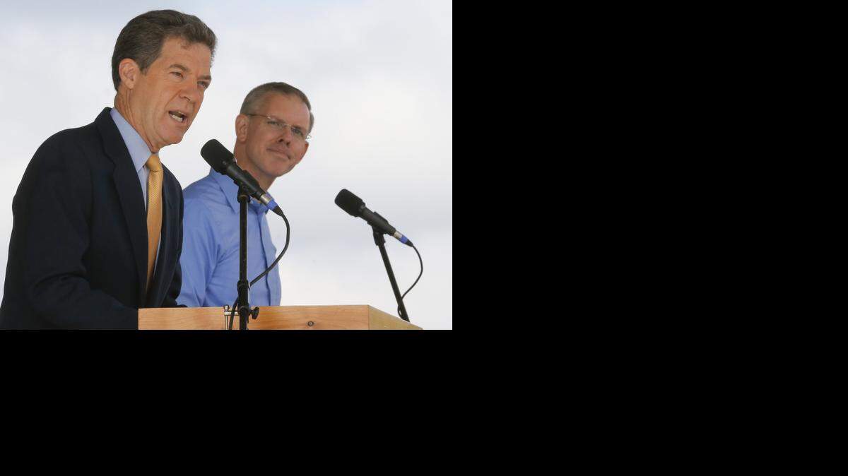 
Kansas governor Sam Brownback speaks while his challenger Paul Davis listens on Saturday at the Kansas State Fair in Hutchinson. 
