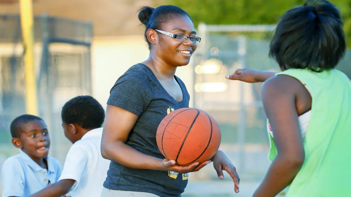 
LaTasha Staley plays with her children, Zreviawn Taylor, 7, Daviaun Gary, 11, and Mychelle Staley, 13, after work Wednesday. (Sept. 2, 2015)
