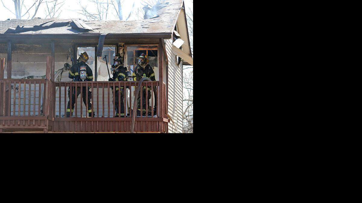 
Wichita firefighters looks for hot spots outside a second floor apartment after a fire in the 1300 block of West Walker on Sunday afternoon.
