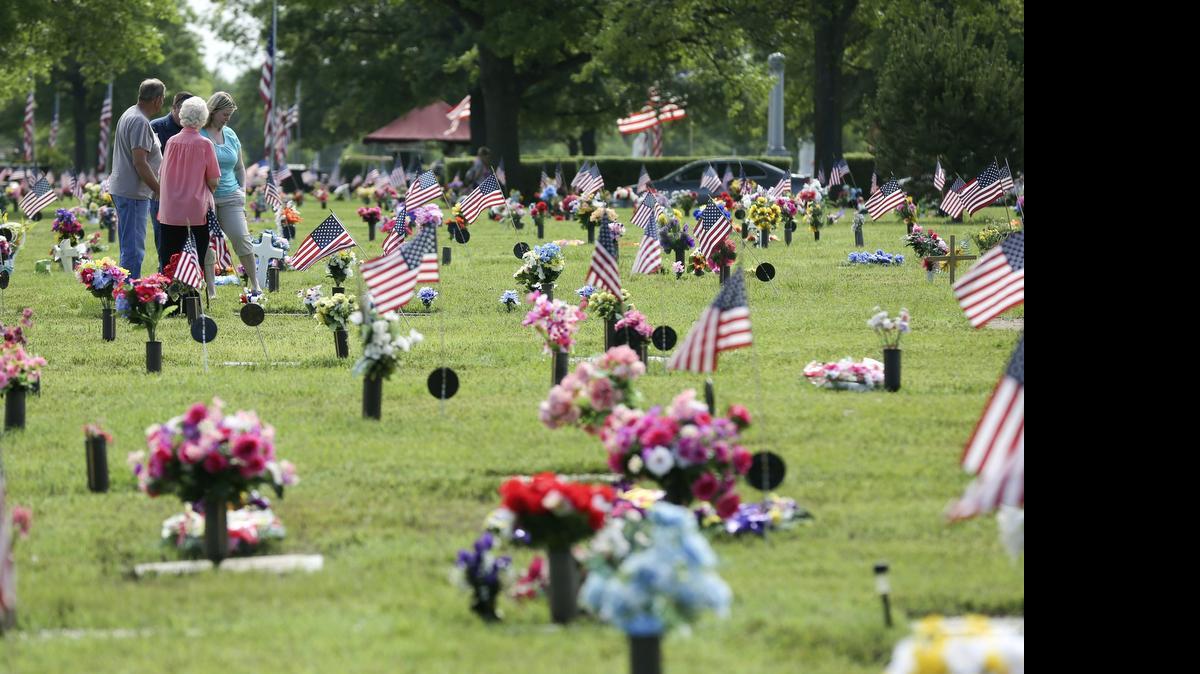 
Resthaven Mortuary and Cemetery is covered in colorful flowers and flags for the annual Memorial Day celebration. (May 26, 2014) 
