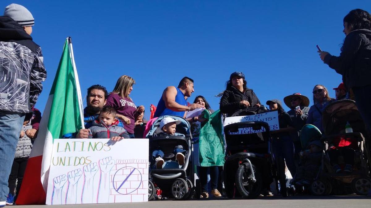 Roberto Ticas, a citizen of El Salvador who has lived in the U.S. for 17 years (center, bare arms), rallies Thursday in Wichita for the opportunity to continue working in the U.S.