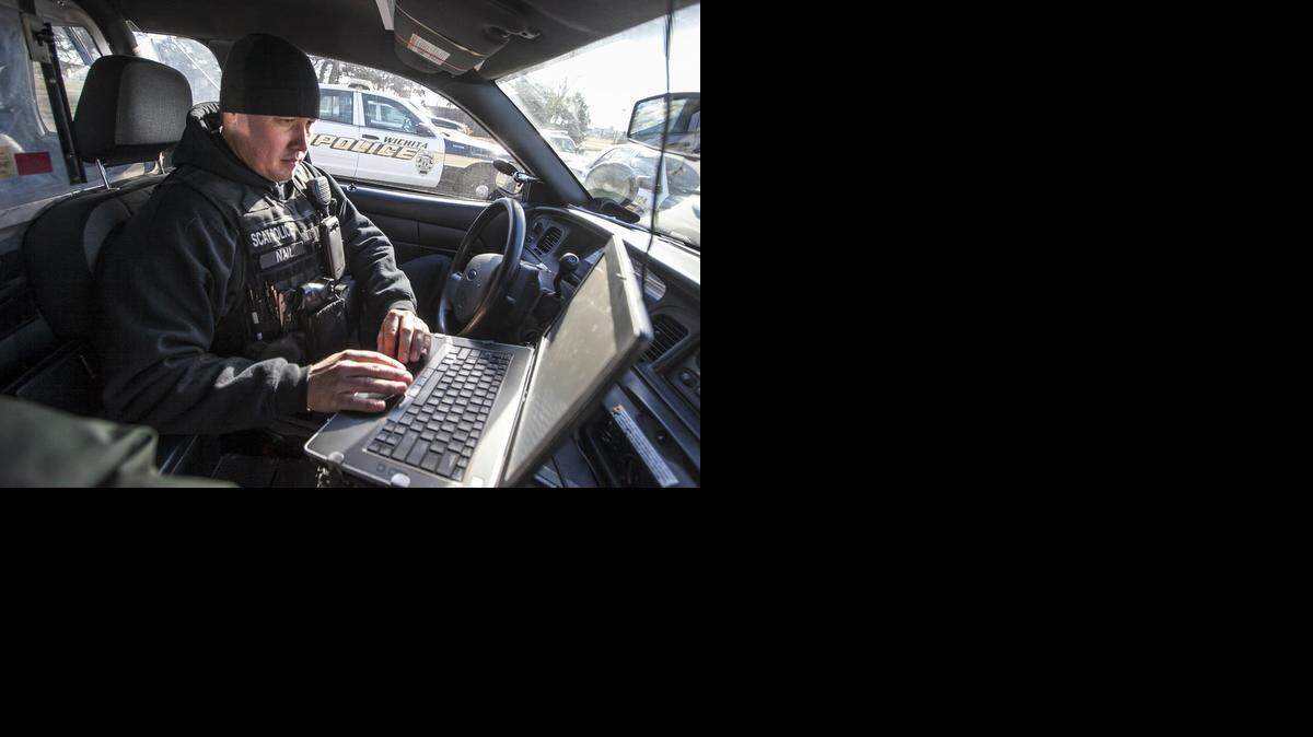 A Wichita police officer works on his computer in this 2014 file photo. Police want to switch to a new records system.