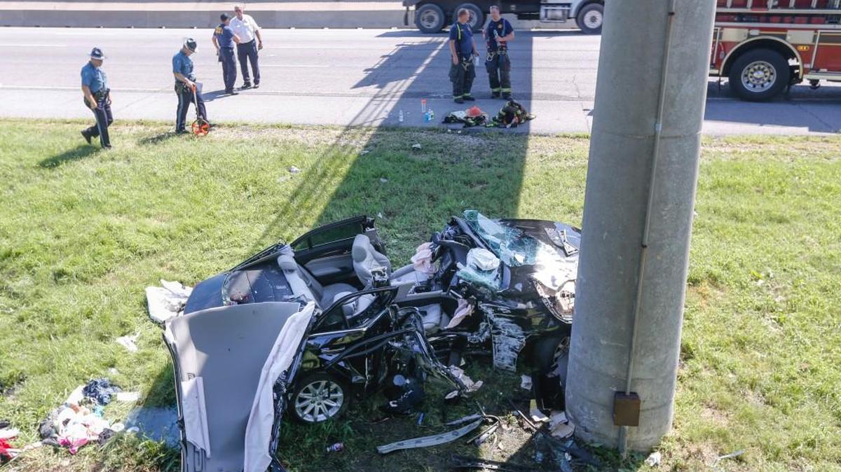 Kansas Highway Patrol troopers investigate where a car collided with a pedestrian bridge pillar on southbound I-135.