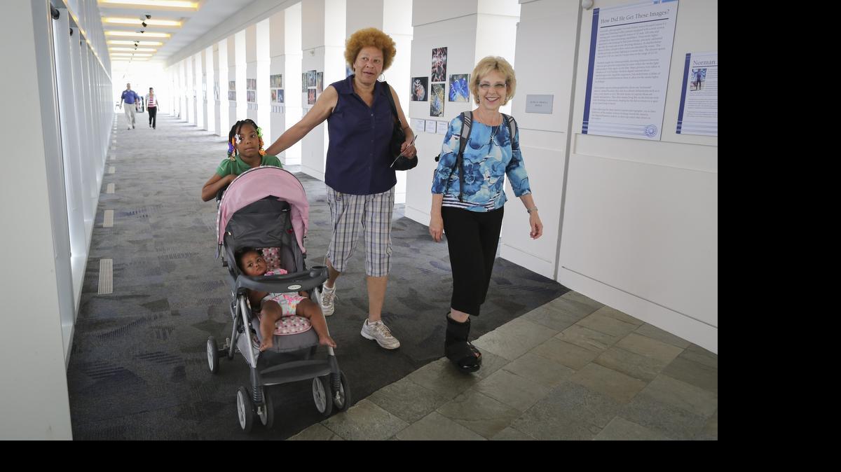 
The Wichita Circles Network pairs volunteers with people who are trying to get out of poverty. Janis Cox, right, has been partnered with Sharon Askew, center, for a couple of years. The duo, along with Askew’s granddaughters Mylan (in stroller) and Mystique, recently visited Exploration Place.

