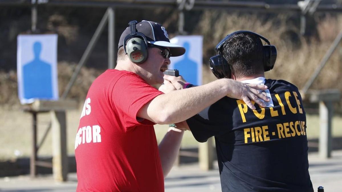 Kansas Law Enforcement Training Center instructor Jeff Elston, left, works with Augusta police officer Caleb Hayes while Hayes goes through shooting drills at the Law Enforcement Training Center in Yoder. (Nov. 10, 2015)