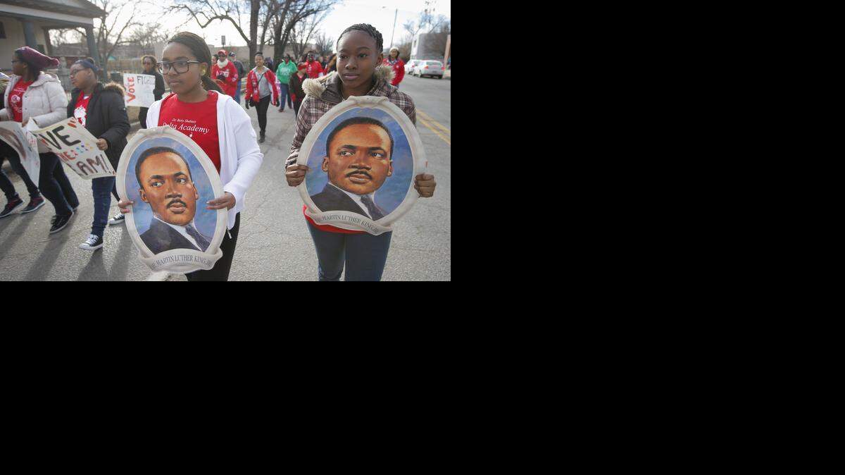 Memorie Brown, right, and Devyn Fields march in the Martin Luther King, Jr. parade on south Broadway on Saturday morning. The parade followed a pancake breakfast and lecture and was one of many events marking the MLK holiday on Monday. See more photos at Kansas.com.
