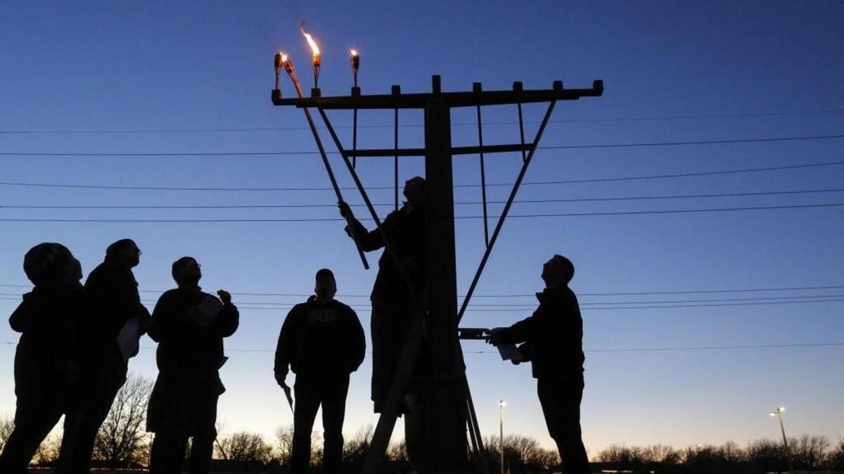 The Hebrew Congregation of Wichita celebrated the “festival of lights” with an outdoor menorah lighting Monday on the third night of Hanukkah. Congregation member Cliff Bayne lit the candles. (Dec. 26, 2016)