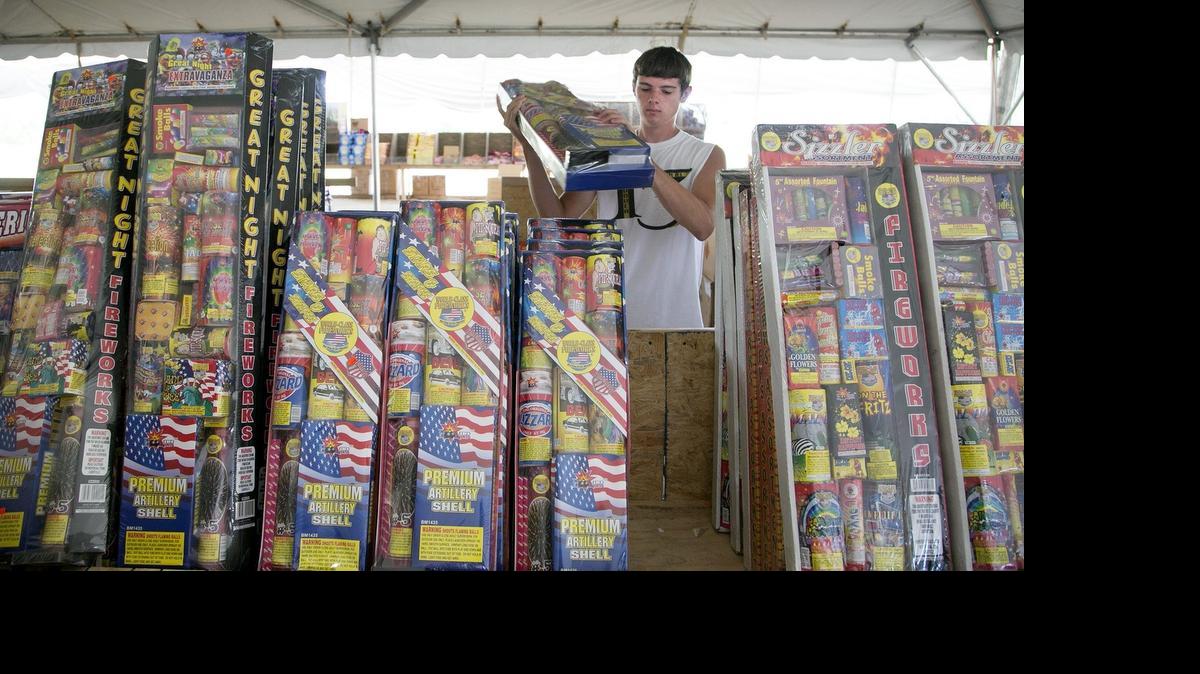 
Josh Sullivan stacks fireworks in a fireworks stand operated by three Lutheran churches at the Sedgwick/Butler county line on Kellogg and 159th Street East. 

