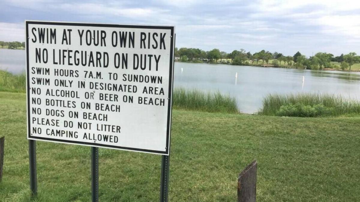 A sign stands on the shore of Lake Afton in this 2017 photo. 