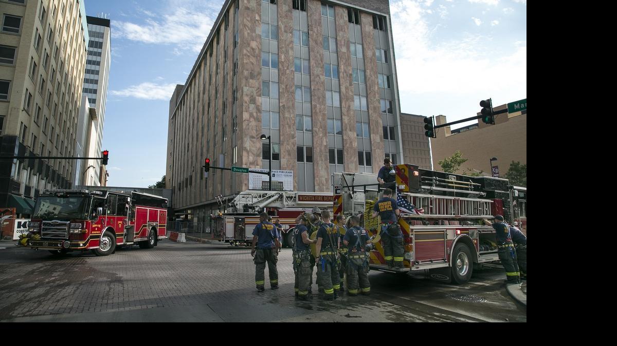 
Firefighters remain on the scene at Douglas and Main in downtown Wichita on Friday. Minor damage was reported by smoke but the morning commute was interrupted for several hours.
