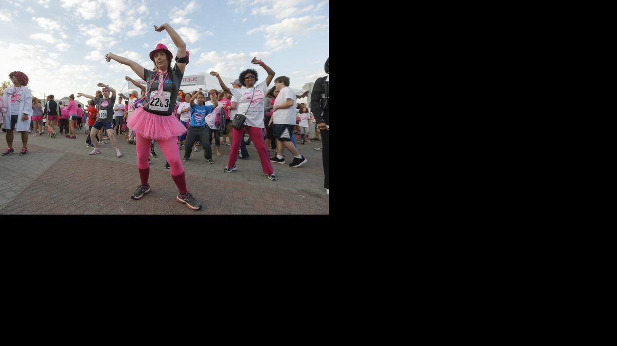
Sheena Elkins dances in the runners village before the Komen Race for the Cure on Saturday morning in downtown Wichita. (Sept. 27, 2014)
