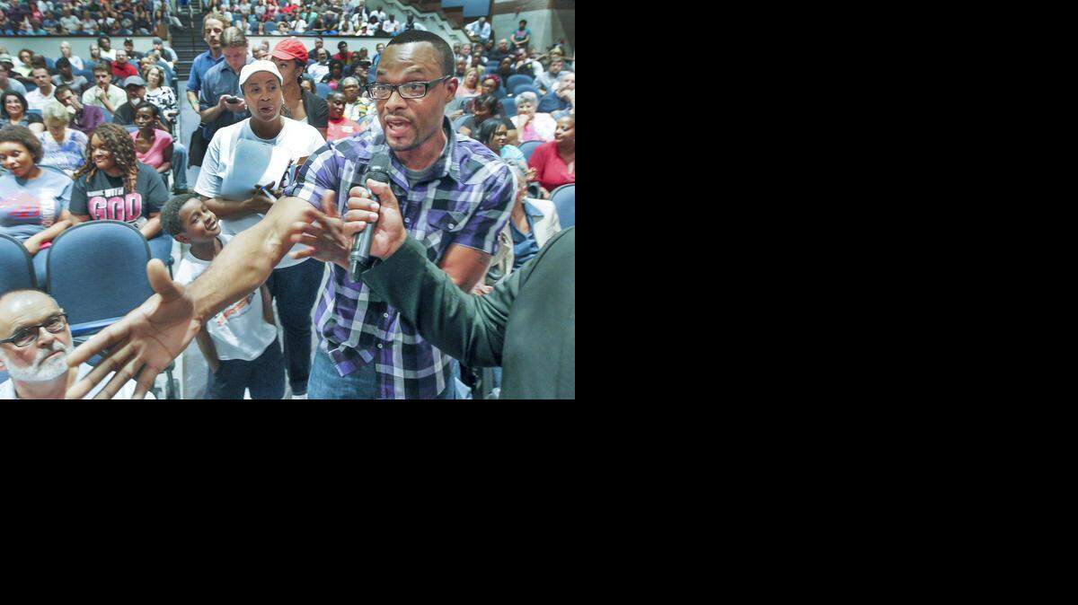 
Dhanraj Fralin expresses his views about a lack of economic power in the black community during a community meeting at East High on Thursday. (Aug. 28, 2014)
