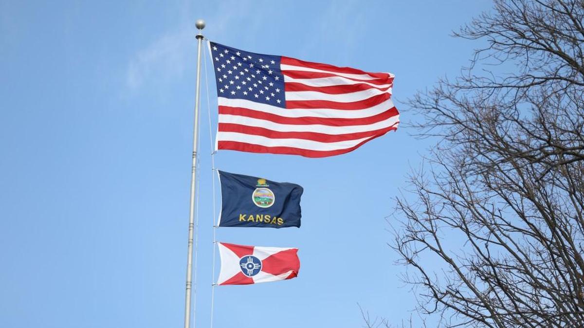 The American, Kansas, and Wichita flag blow in the wind during a gusty Kansas day. (Dec. 11, 2017)