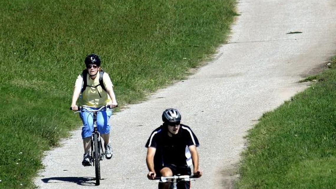 Cyclists bike on one of the Wichita’s bike paths near the Arkansas River. Wichita and Tulsa embrace the idea of bike paths and creating walkable cities.
