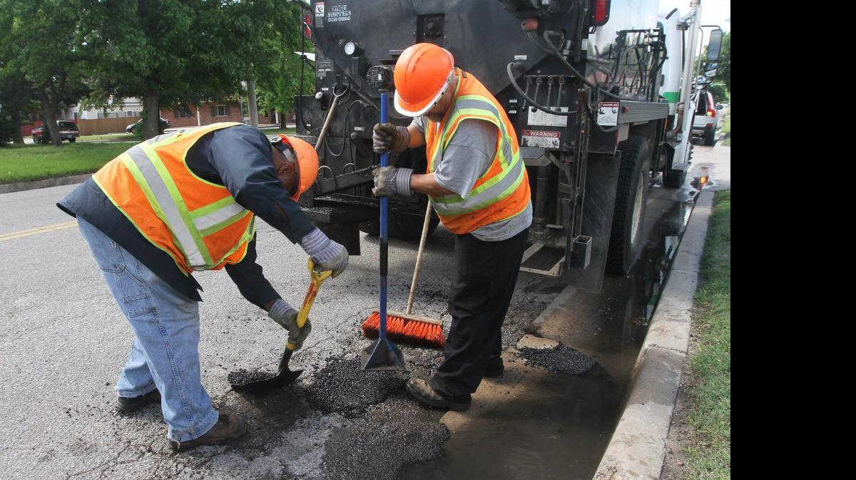 
A crew from Wichita Public Works and Utilities work on potholes on Waco north of Murdock on Thursday afternoon. (May 28, 2015)
