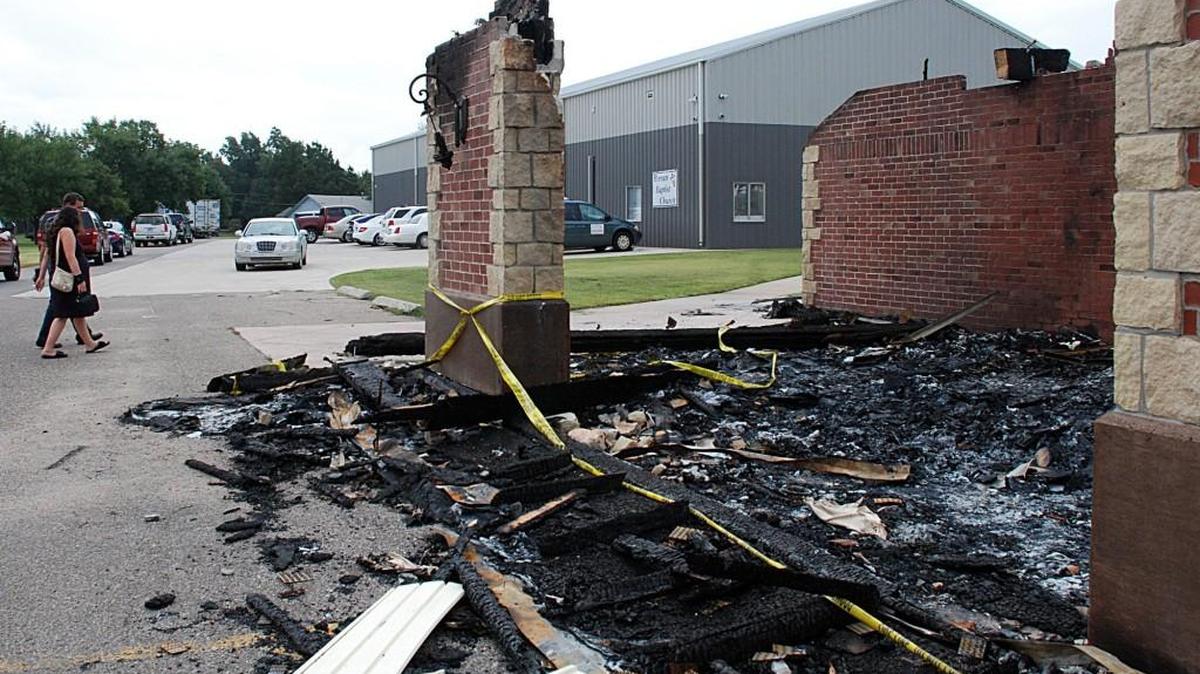 
Church members walk past the rubble of Berean Baptist Church to attend services Sunday in the gymnasium owned by the church.
