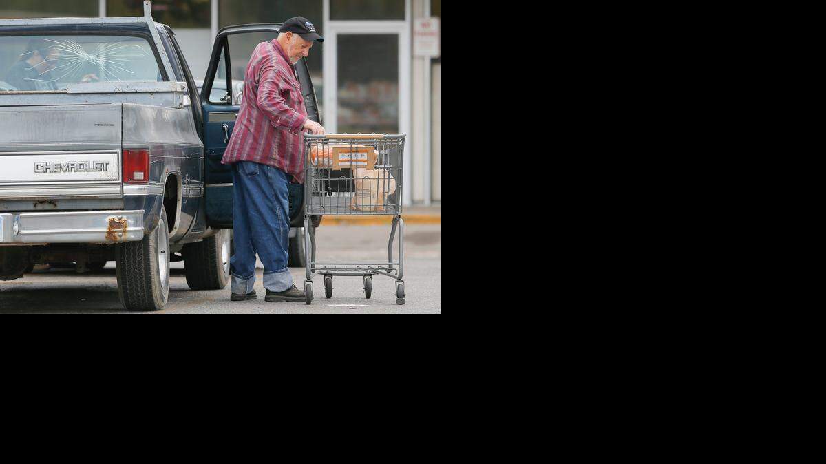 
FILE A shopper unloads his shopping cart in the parking lot of the Dillon's store near Broadway and Harry this summer. The Dillon's store closed a few days later, increasing the size of the food desert for those living in the area. 
