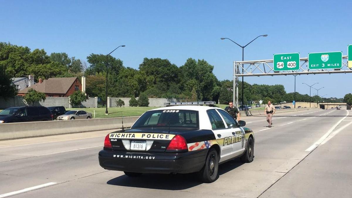 
Wichita police officers divert traffic off of eastbound Kellogg at Oliver on Friday afternoon.
